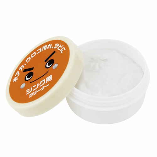 研磨クリーム　激落ちくん　シンク用　クリーナー　クエン酸　水垢 製品のパッケージが斜め上から見える状態で、側面に特徴的なデザインが施されている。