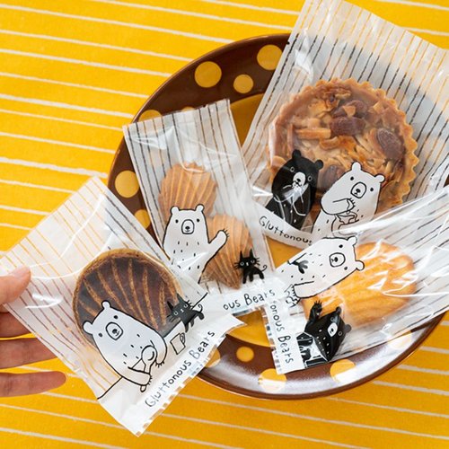 テープ無 OPP袋 グラットンベアスイーツパック クリア-2(100枚) ヘッズ 透明な袋に入ったお菓子の束、底部が見える状態
