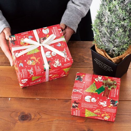クリスマスジョリーバンド包装紙-1(50枚) ヘッズ ためらいなくクリスマスのイラストが描かれた包装紙が束になっている状態