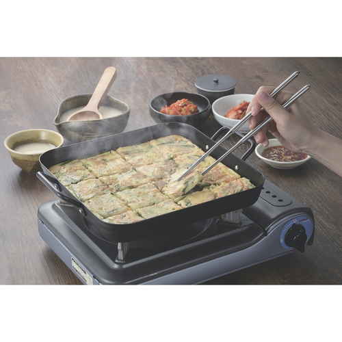 角型プレート　25×25cm　IH対応　鉄製　韓味家　チヂミパン 平たくて深さのない四角形の黒いプレートがテーブルに置かれた状態