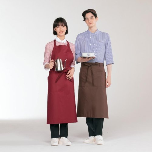 胸当てエプロン エプロン 兼用 ボトルグリーン 2way 住商モンブラン [ケース販売] 明るいボトルグリーンの生地で、胸当て部分が特徴的なエプロンが垂直に立てられた様子