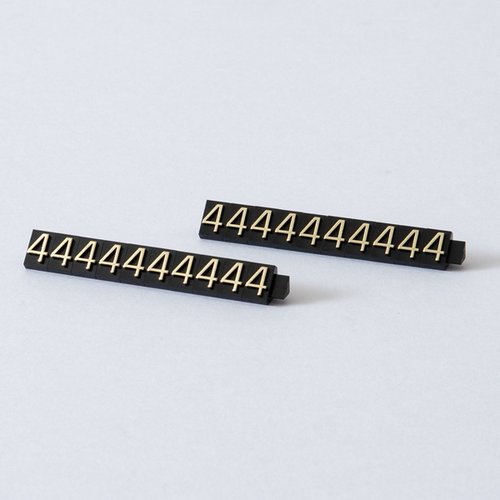 陳列備品 ニュープライスキューブ補充L用(20粒) 黒/金 4 友屋 黒と金のシンプルなデザインで整然と並んだプラスチック製の補充パーツが見える状態