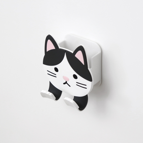 フック　吸着　スティッキーフックポケット　アニマル　ハチワレ 上向きに座っている白黒の猫のデザイン、バックには吸着面がある。