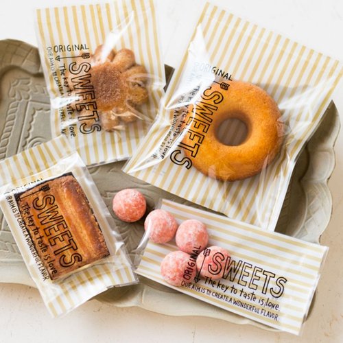 ハッピータイムスイーツパック クリア-9冷凍可(100枚) ヘッズ 透明なパッケージに収められた、重なった状態のスイーツパック。